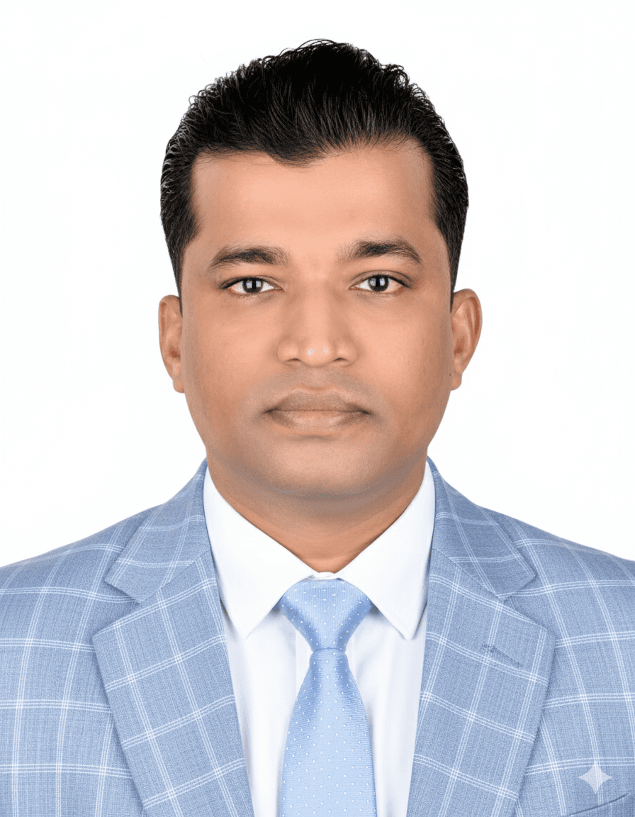 Professional headshot of a man wearing a light blue plaid suit and a blue tie.